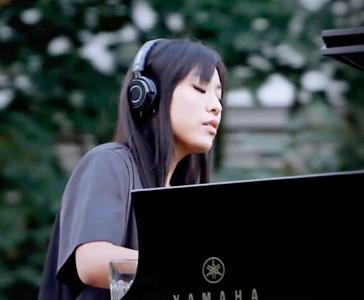 Pianist playing a Silent piano using headphones