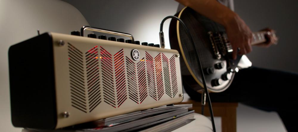 Photo of someone playing a Revstar guitar through a THR amp