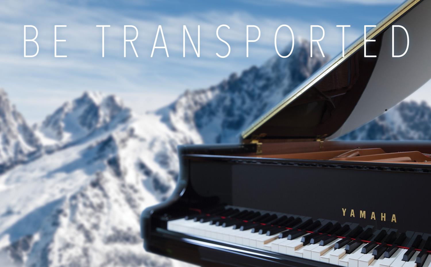 Photo of a Yamaha Disklavier Grand Piano on the summit of a mountain, overlooking a mountain range