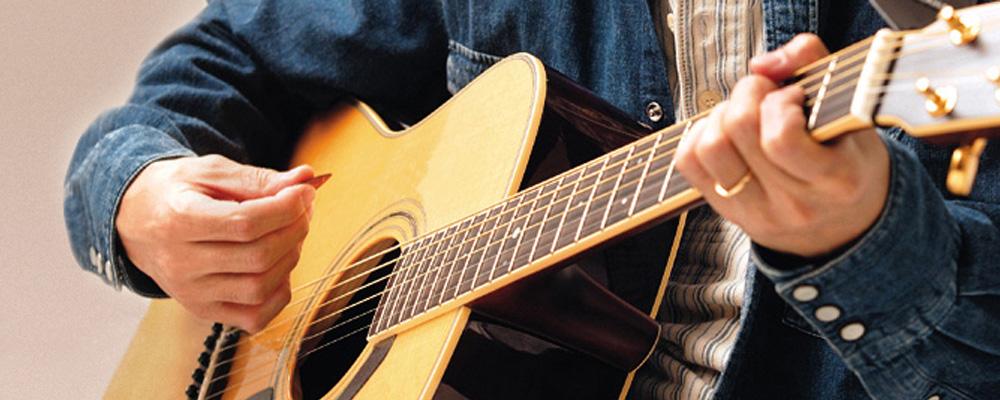 A guitarist playing an acoustic guitar